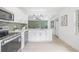 A stylish kitchen boasts stainless appliances, shaker cabinets, and an open layout to the living area at 7991 54Th N St, Pinellas Park, FL 33781