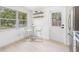 Sun-lit kitchen nook with modern seating, a window, and access to the back door at 7991 54Th N St, Pinellas Park, FL 33781