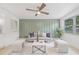 Comfortable living room boasts modern decor, a plush sofa, stylish ottomans, and a large window for natural light at 7991 54Th N St, Pinellas Park, FL 33781