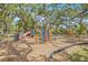 Community playground features a variety of play structures, seating, and mature shade trees at 7991 54Th N St, Pinellas Park, FL 33781