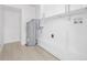 Utility room features modern tank water heater, white paint, and durable flooring at 7991 54Th N St, Pinellas Park, FL 33781