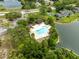 Aerial view of a community pool, cabana, parking area, and pond at 8175 Sturbridge # 8175, Weeki Wachee, FL 34613