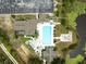 Aerial view of community pool, parking, pond, and landscaping at 8175 Sturbridge # 8175, Weeki Wachee, FL 34613