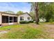Backyard featuring screened patio, landscaping, and mature trees at 8175 Sturbridge # 8175, Weeki Wachee, FL 34613