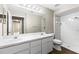 Well-lit bathroom featuring double sinks and a walk-in shower with nice tile work at 8175 Sturbridge # 8175, Weeki Wachee, FL 34613