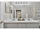 Bright bathroom featuring a double sink vanity with modern fixtures and large mirror at 8175 Sturbridge # 8175, Weeki Wachee, FL 34613