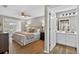 Primary bedroom with view of bathroom featuring dual vanity, well lit mirror, and wood floors at 8175 Sturbridge # 8175, Weeki Wachee, FL 34613