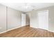 Bedroom with wood-look flooring, ceiling fan, and double door closet at 8175 Sturbridge # 8175, Weeki Wachee, FL 34613