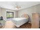 Comfortable bedroom with a ceiling fan, wood flooring, and sliding doors to the patio at 8175 Sturbridge # 8175, Weeki Wachee, FL 34613