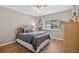 Comfortable bedroom with beautiful wood floors, a ceiling fan, and a large window at 8175 Sturbridge # 8175, Weeki Wachee, FL 34613