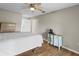 Cozy bedroom with wood-look floors, ceiling fan and neutral color scheme at 8175 Sturbridge # 8175, Weeki Wachee, FL 34613