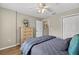 Bedroom with wood floors, ceiling fan, and double door closet at 8175 Sturbridge # 8175, Weeki Wachee, FL 34613