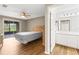 Bedroom featuring wood floors, access to a screened-in porch, and a full bathroom at 8175 Sturbridge # 8175, Weeki Wachee, FL 34613