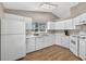 Clean kitchen featuring white cabinetry, matching appliances, and ample counter space at 8175 Sturbridge # 8175, Weeki Wachee, FL 34613