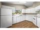 Functional kitchen featuring modern appliances, white cabinets, and plenty of countertop space at 8175 Sturbridge # 8175, Weeki Wachee, FL 34613
