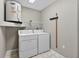 Laundry room featuring a washer, dryer, storage shelves and an efficient water heater at 8175 Sturbridge # 8175, Weeki Wachee, FL 34613