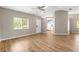 Bright living room with wood floors, neutral walls, and a view into the kitchen area at 8175 Sturbridge # 8175, Weeki Wachee, FL 34613