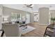 Cozy living room featuring wood-look flooring, large window, and neutral color palette at 8175 Sturbridge # 8175, Weeki Wachee, FL 34613