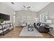 Open living room with vaulted ceiling, modern furnishings, and wood-look flooring at 8175 Sturbridge # 8175, Weeki Wachee, FL 34613