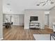 Bright living room featuring wood floors, a ceiling fan, and access to the outdoor patio at 8175 Sturbridge # 8175, Weeki Wachee, FL 34613