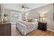 Primary bedroom with wood floors, a ceiling fan, and access to the outdoor patio at 8175 Sturbridge # 8175, Weeki Wachee, FL 34613