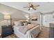 Comfortable bedroom with a large bed, ceiling fan, and bedside lamps at 8175 Sturbridge # 8175, Weeki Wachee, FL 34613