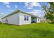 Spacious backyard with green grass, perfect for outdoor activities and relaxation at 8192 Ivy Stark Blvd, Wesley Chapel, FL 33545