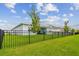 Enjoy the private backyard with its lush green grass and wrought iron fence at 8192 Ivy Stark Blvd, Wesley Chapel, FL 33545