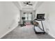 Spacious room with ceiling fan, gray carpet, and large window perfect for a home gym or office at 8192 Ivy Stark Blvd, Wesley Chapel, FL 33545