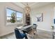 Dining room features a modern chandelier, large window, and stylish decor at 8192 Ivy Stark Blvd, Wesley Chapel, FL 33545