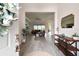 Welcoming foyer with wood-look tile flooring and an open view to living area at 8192 Ivy Stark Blvd, Wesley Chapel, FL 33545