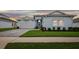 Charming single-story home with a well-manicured lawn and a two-car garage at 8192 Ivy Stark Blvd, Wesley Chapel, FL 33545