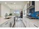 Well-appointed kitchen features a center island, modern appliances, and a view into the dining area at 8192 Ivy Stark Blvd, Wesley Chapel, FL 33545