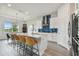 Bright kitchen with white cabinets, stainless steel appliances, and a breakfast bar at 8192 Ivy Stark Blvd, Wesley Chapel, FL 33545