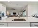 Open-concept kitchen with a large island featuring a stainless steel sink and seating at 8192 Ivy Stark Blvd, Wesley Chapel, FL 33545
