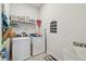The laundry room is equipped with a washer, dryer, shelving, storage, and a sink at 8192 Ivy Stark Blvd, Wesley Chapel, FL 33545