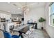 Bright and airy open-concept space with view of the kitchen, dining area, and living room at 8192 Ivy Stark Blvd, Wesley Chapel, FL 33545