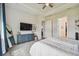 Relaxing main bedroom with soft gray carpet, a ceiling fan, and access to an ensuite bathroom and walk-in closet at 8192 Ivy Stark Blvd, Wesley Chapel, FL 33545