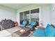 This outdoor patio has comfortable seating, a grill, and a stylish rug for relaxing and entertaining at 8192 Ivy Stark Blvd, Wesley Chapel, FL 33545