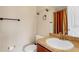 Bathroom featuring a sink with a golden faucet and a toilet providing essential amenities at 9013 White Sage Loop, Lakewood Ranch, FL 34202