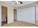 Bedroom with neutral carpet and a closet, providing convenient storage space, with a partial view of bathroom at 9013 White Sage Loop, Lakewood Ranch, FL 34202