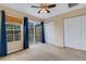 Bright bedroom featuring a ceiling fan, closet, and natural light at 9013 White Sage Loop, Lakewood Ranch, FL 34202