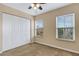Bedroom featuring carpet, ceiling fan, a closet, and two windows illuminating the interior at 9013 White Sage Loop, Lakewood Ranch, FL 34202
