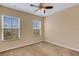 Bedroom with ceiling fan and two windows showcasing the outside view, providing natural light at 9013 White Sage Loop, Lakewood Ranch, FL 34202