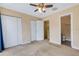 Bedroom with ceiling fan and ensuite bathroom and closet access at 9013 White Sage Loop, Lakewood Ranch, FL 34202