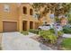 Well-maintained two-story townhome with a two car garage, manicured landscaping, and long driveway at 9013 White Sage Loop, Lakewood Ranch, FL 34202