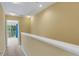 Hallway with neutral colors and an open balcony, creating an inviting and bright transition between spaces at 9013 White Sage Loop, Lakewood Ranch, FL 34202
