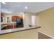 Functional kitchen with wood cabinets, tile floors and efficient lighting at 9013 White Sage Loop, Lakewood Ranch, FL 34202