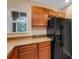 Modern kitchen featuring wood cabinets and black refrigerator at 9013 White Sage Loop, Lakewood Ranch, FL 34202
