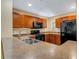 Well-equipped kitchen featuring dark appliances and ample counter space at 9013 White Sage Loop, Lakewood Ranch, FL 34202